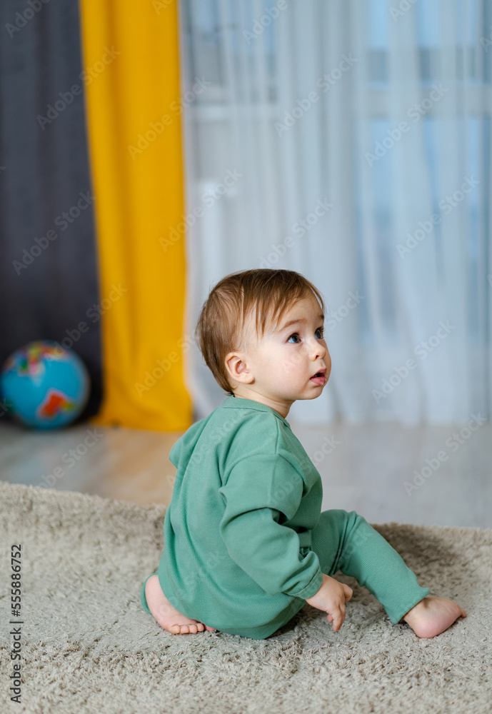 Little toddler boy close up in his house. Handsome toddler portrait.