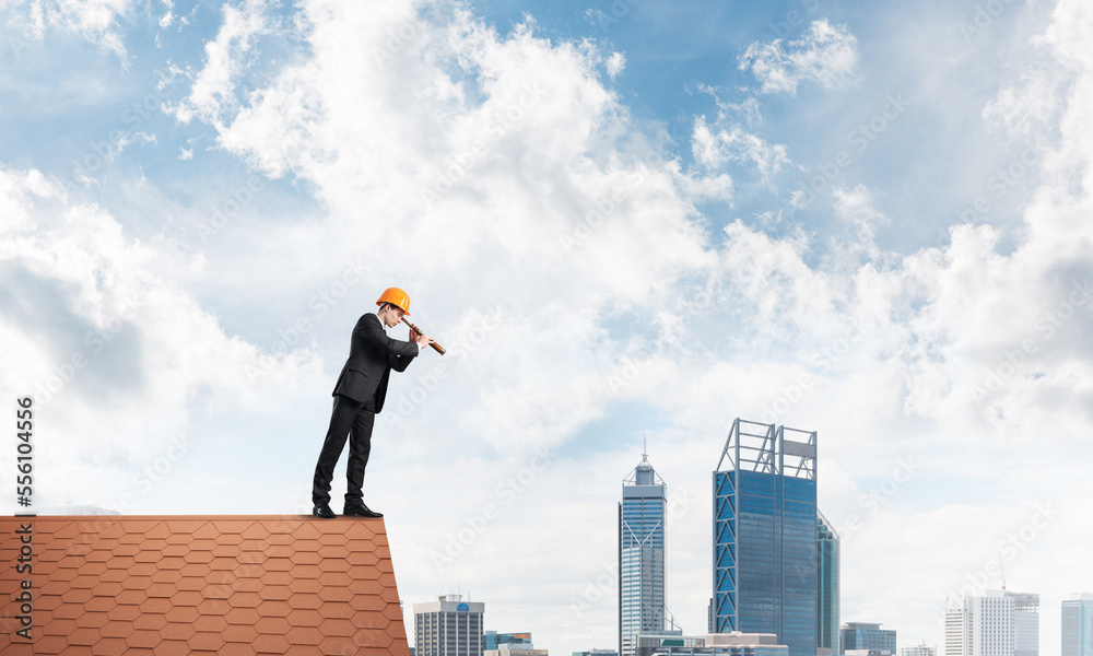 Engineer man standing on roof and looking in spyglass. Mixed media