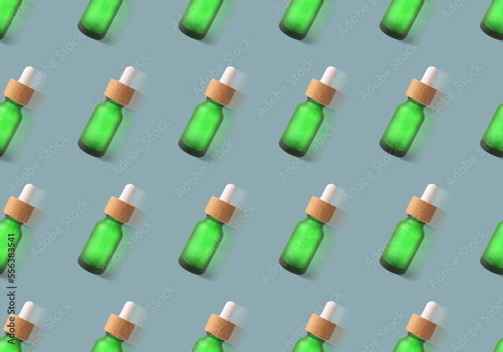 Many bottles of essential oil on grey background. Pattern for design