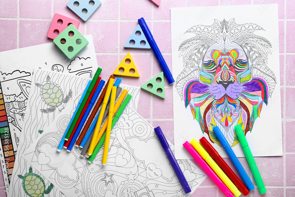 Coloring pages, felt-tip pens and toys on pink tile background