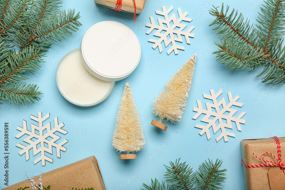 Composition with jar of cream, fir branches and Christmas decor on color background