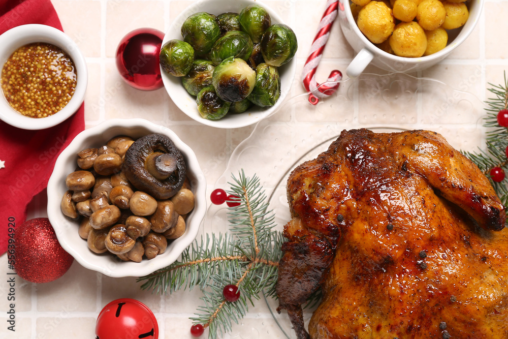 Plate with tasty chicken, garnish and Christmas decor on beige tile background