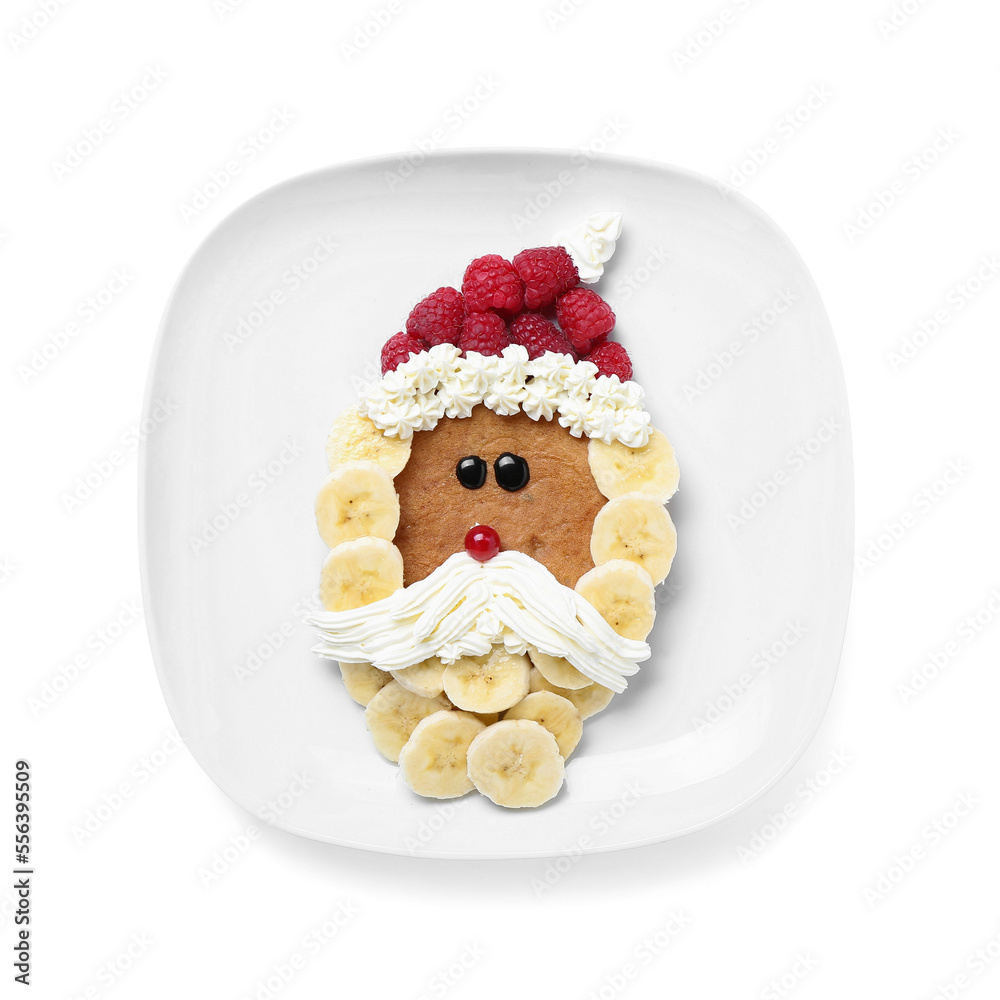 Plate with Santa Claus made of pancake, fruits and whipped cream on white background