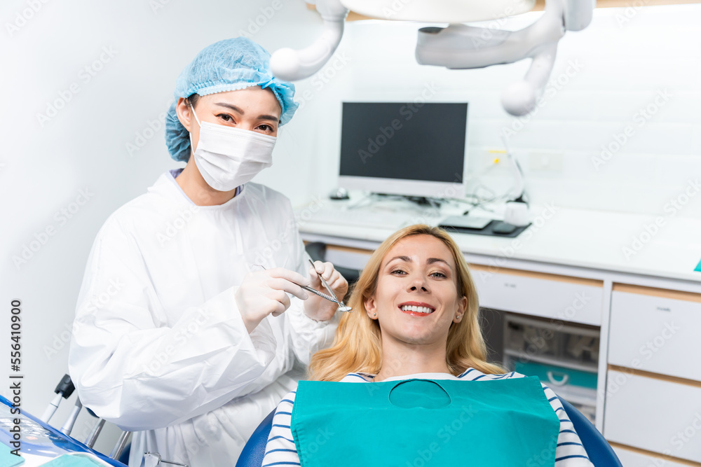 Portrait of Caucasian woman patient and dentist at health care clinic. 