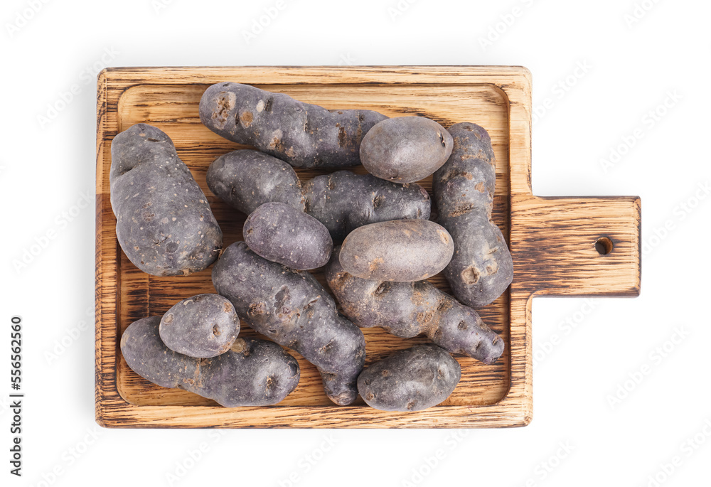 Board of raw purple potatoes on white background