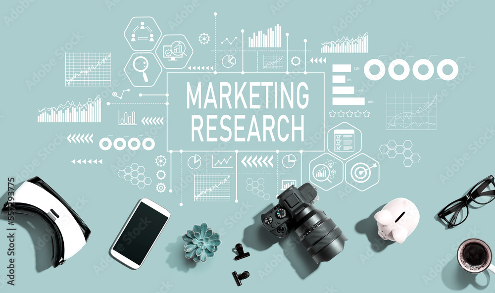 Marketing Research theme with electronic gadgets and office supplies - flat lay