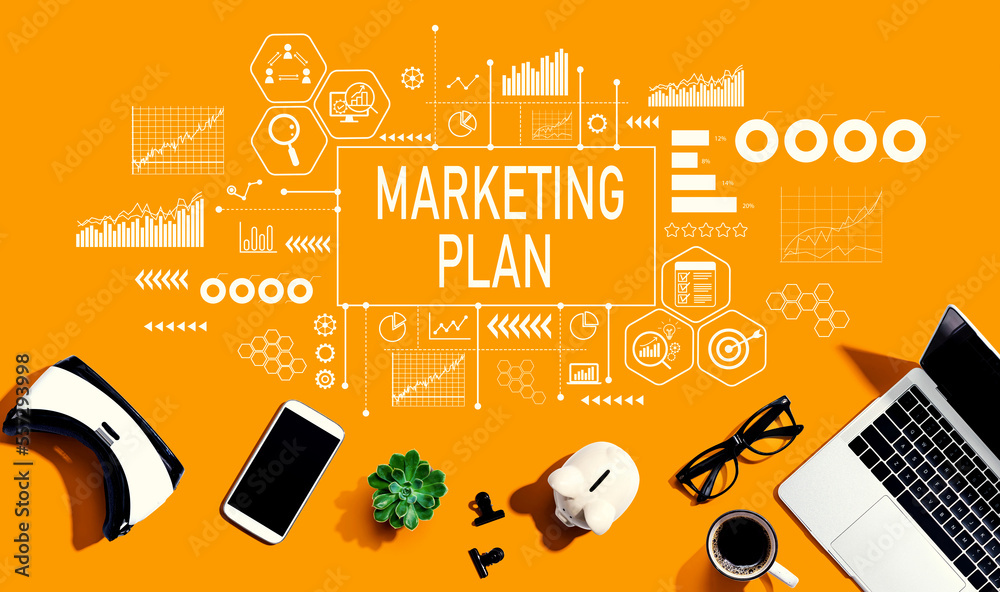 Marketing plan theme with electronic gadgets and office supplies - flat lay