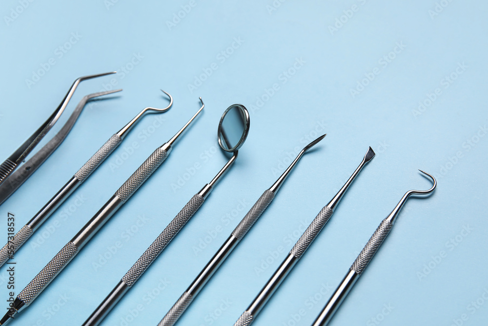 Different dental tools on blue background