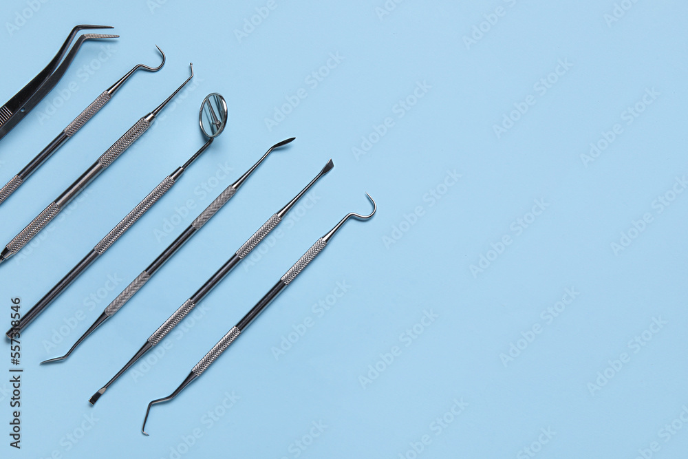 Different dental tools on blue background