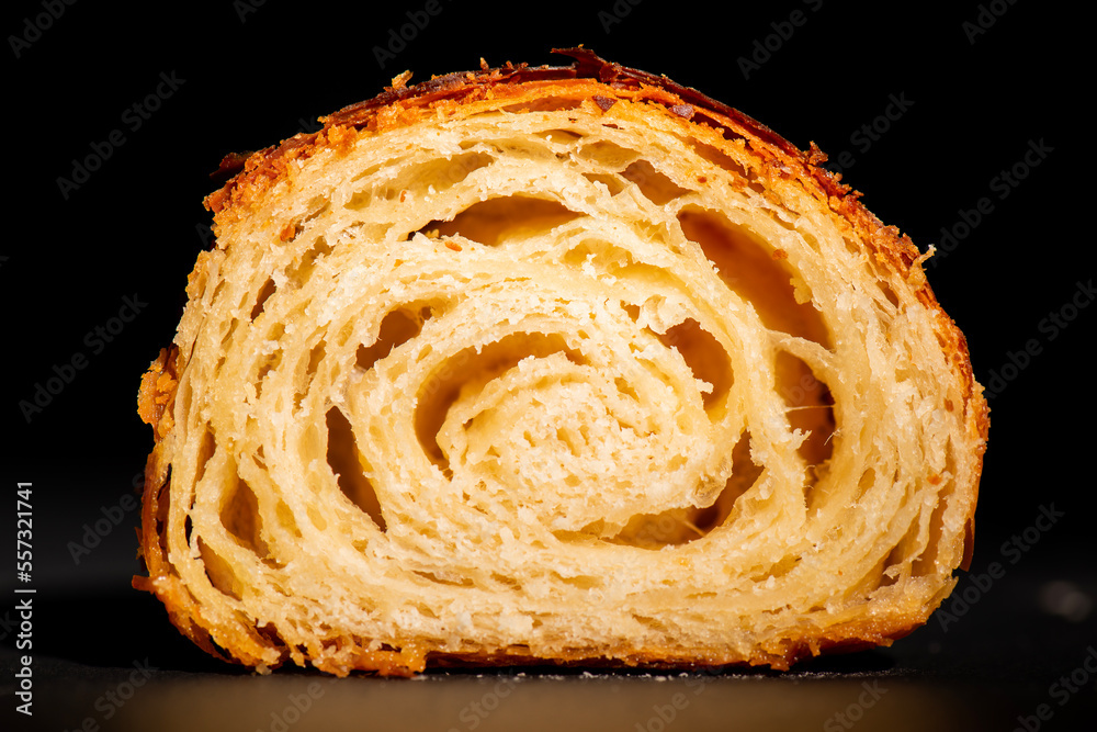 Detailed and closeup photo of a freshly baked plain buttery and flaky croissant.