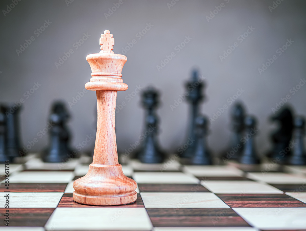 Lone chess king is standing in front of the formation of the opponents pieces. Selective focus. Opp