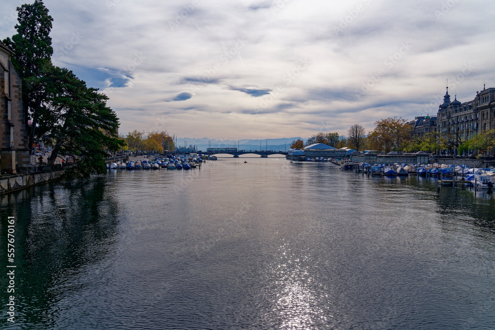 Beautiful scenic view of Limmat River, Quay Bridge, Lake Zürich and Swiss Alps seen from the old tow