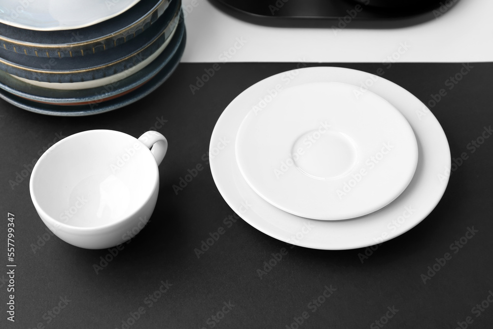 Plates with cup on black and white table