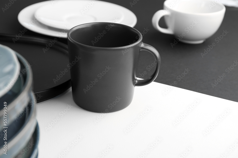 Mug on black and white table, closeup