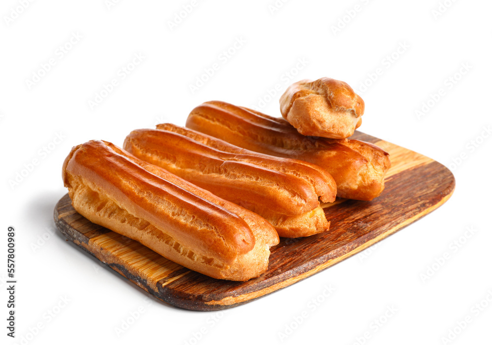 Wooden board with sweet eclairs isolated on white background