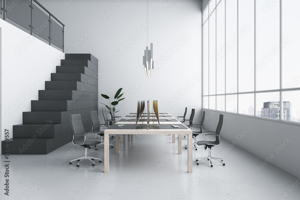 Stylish workspace in coworking office with monochrome interior design, dark stairway, light wooden t