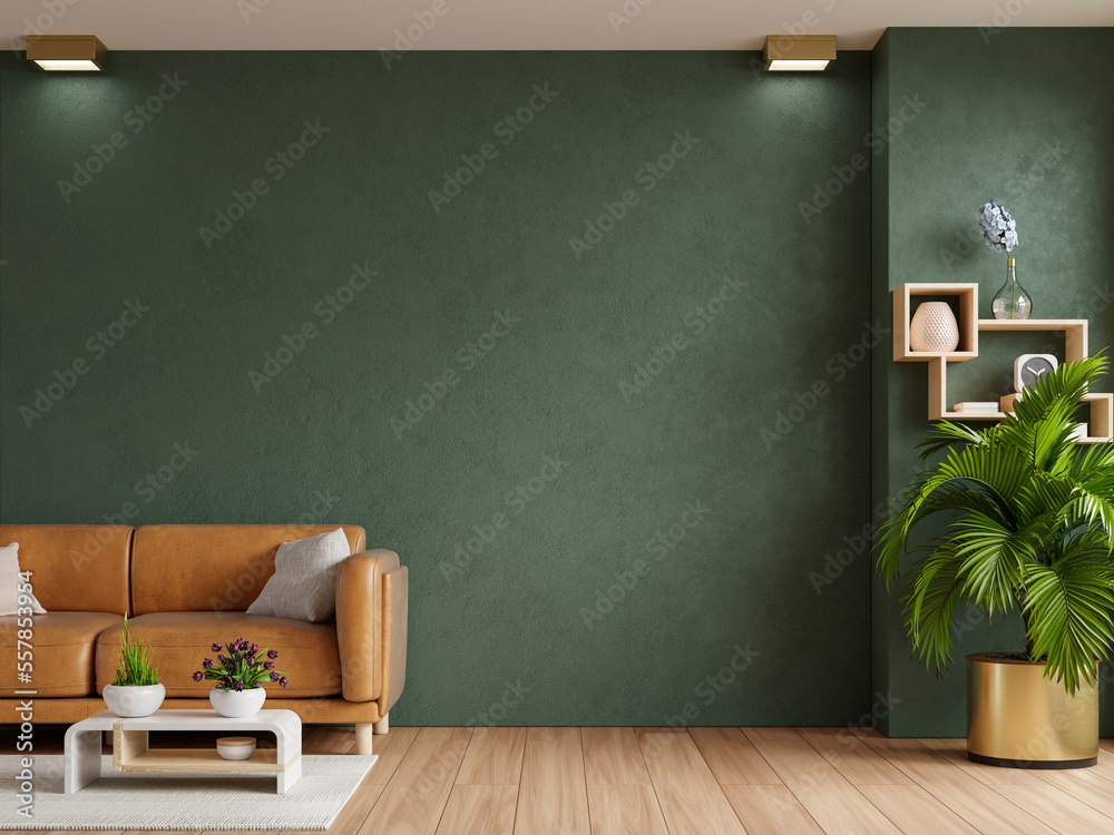 Living room with leather sofa and accessories on empty dark green wall background.