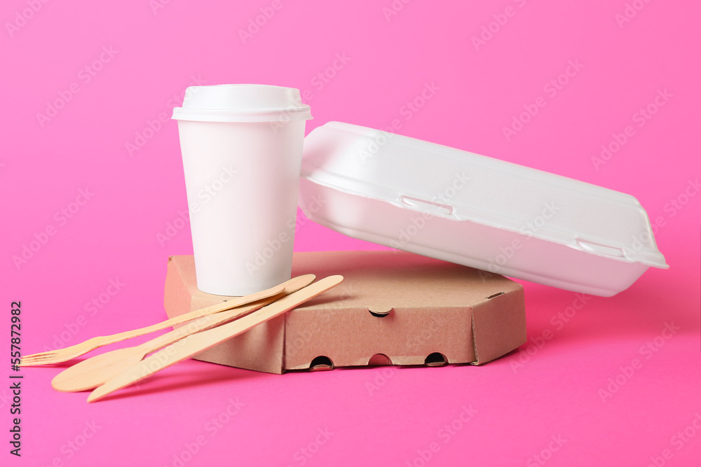 Food boxes, paper cup and wooden cutlery on color background