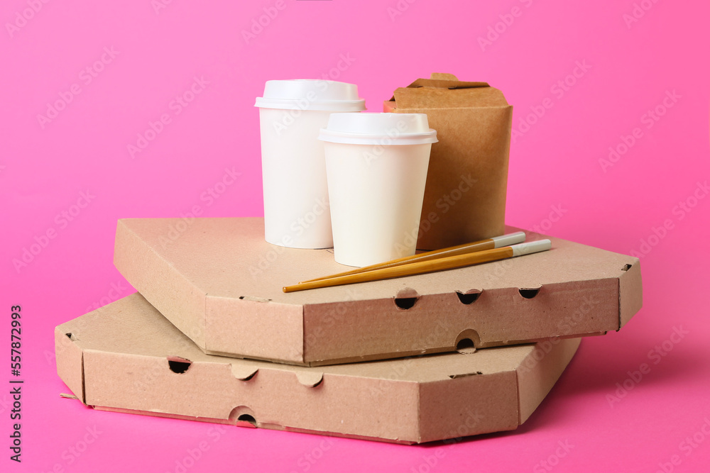 Assortment of food delivery containers on color background