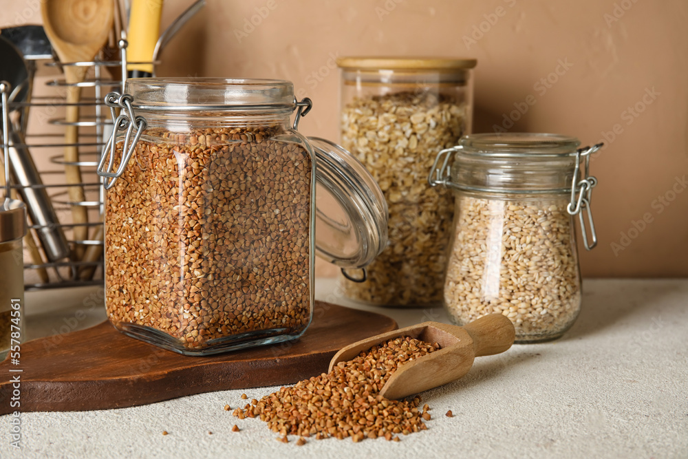 Jars with cereals on table, closeup