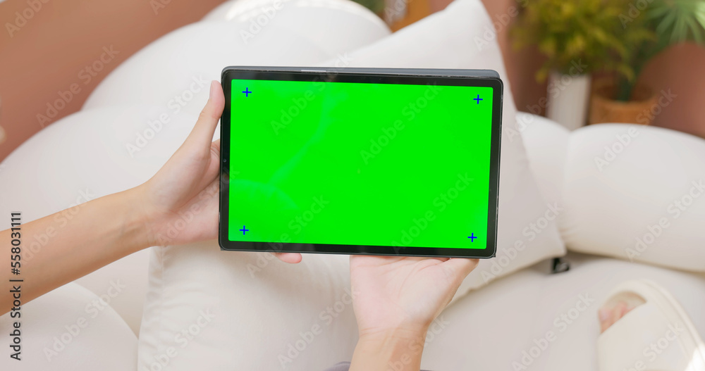 woman hold green screen touchpad