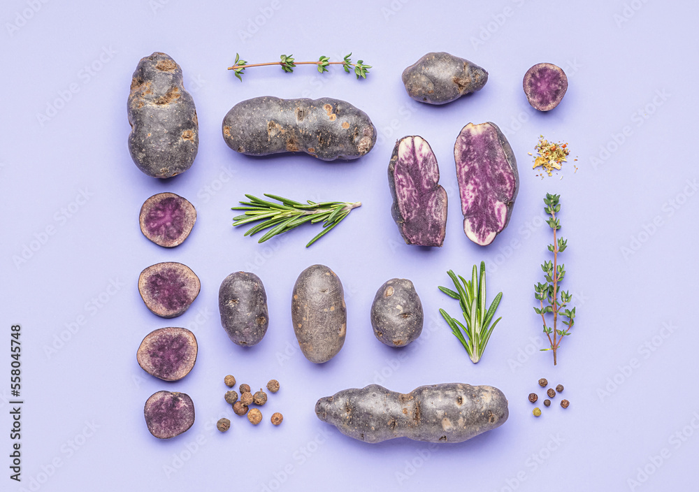 Composition with whole and cut purple potatoes, herbs and spices on lilac background