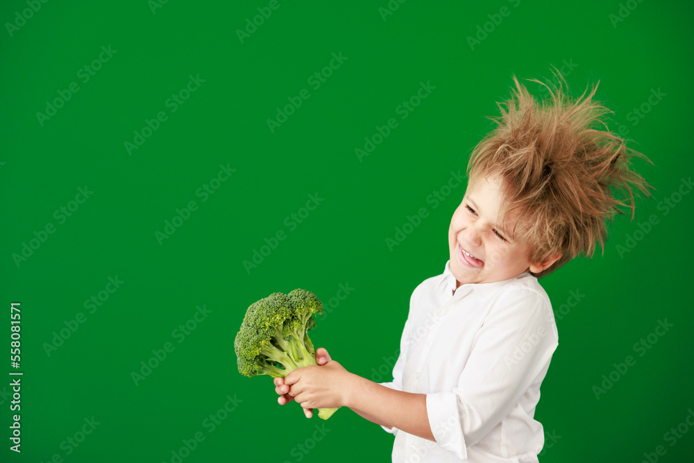 Surprised child against green chalkboard in class