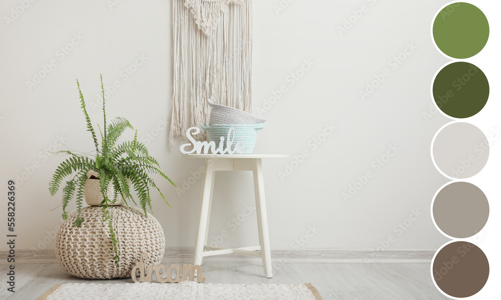 Knitted pouf with houseplant and table with baskets near light wall in room. Different color pattern