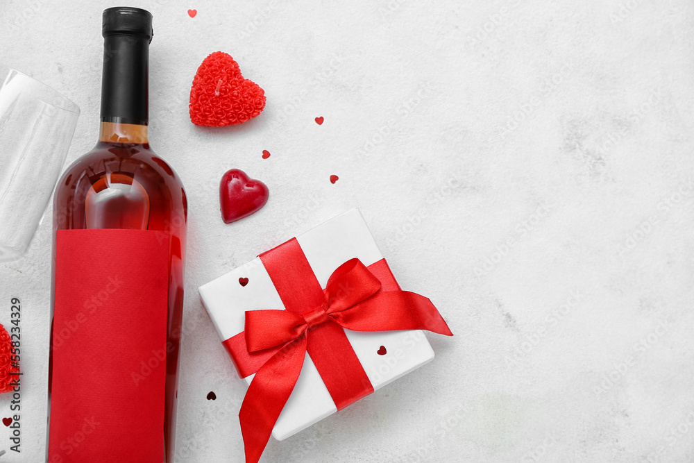 Bottle of wine with gift and hearts on white background. Valentines Day celebration