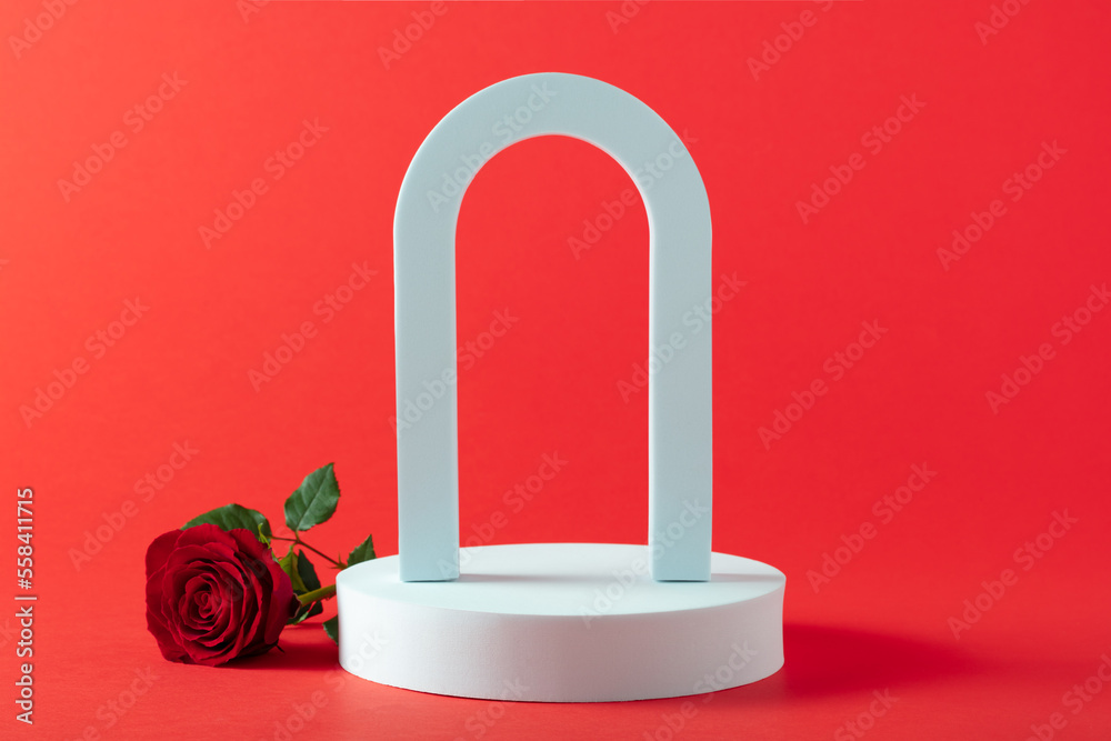 Abstract empty white podium with arch, hearts and rose flowers on red background. Mock up stand for 