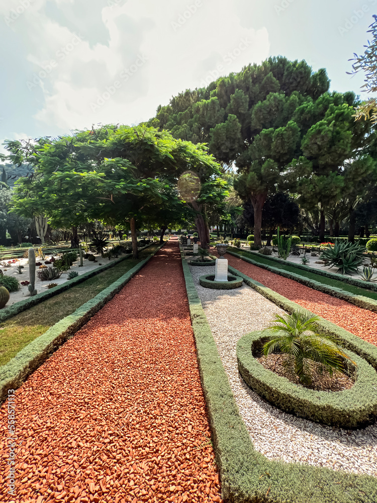 View of beautiful park with pathway and flower beds