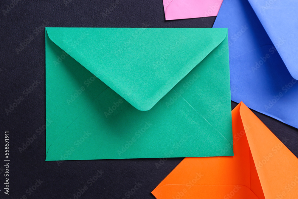 Different paper envelopes on dark background, closeup