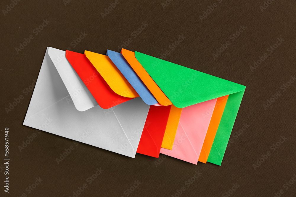 Colorful paper envelopes on dark background