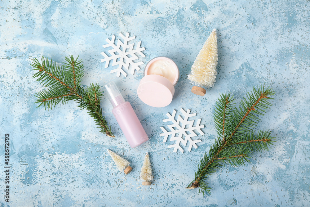 Composition with cosmetic products, Christmas decorations and fir branches on color background