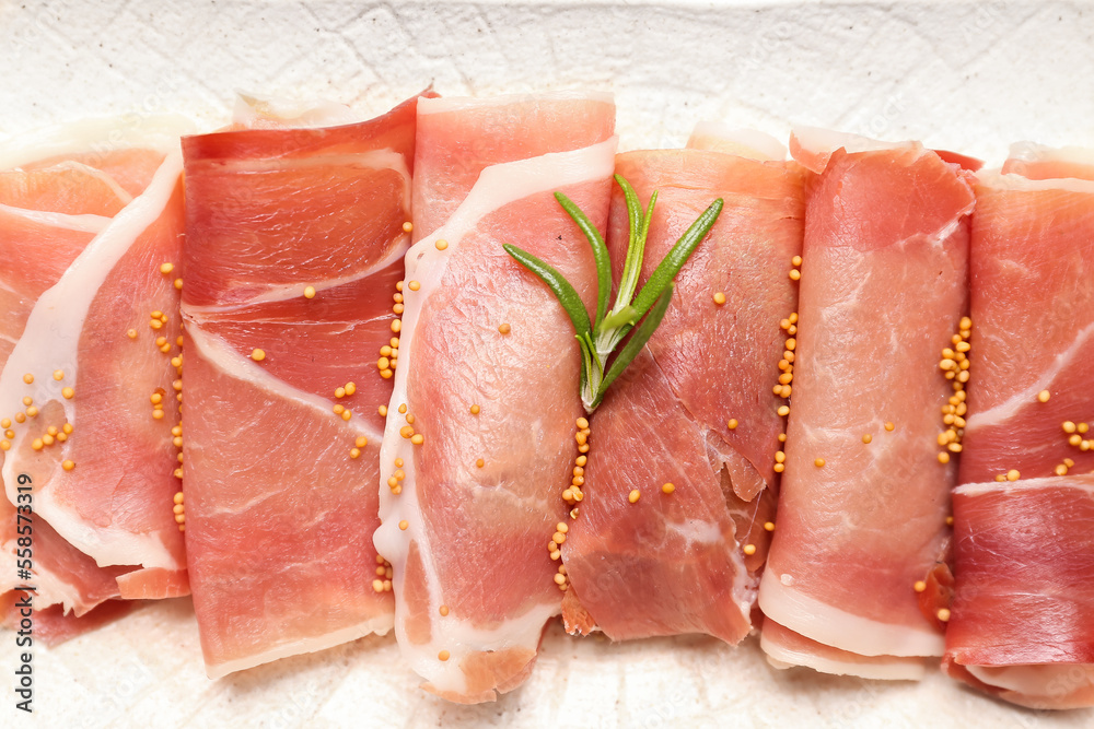 Slices of tasty ham with mustard seeds on plate, closeup