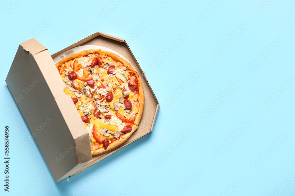 Cardboard box with delicious pizza on color background