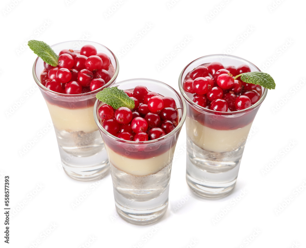 Shots of delicious pudding with cranberry, mint and jam isolated on white background