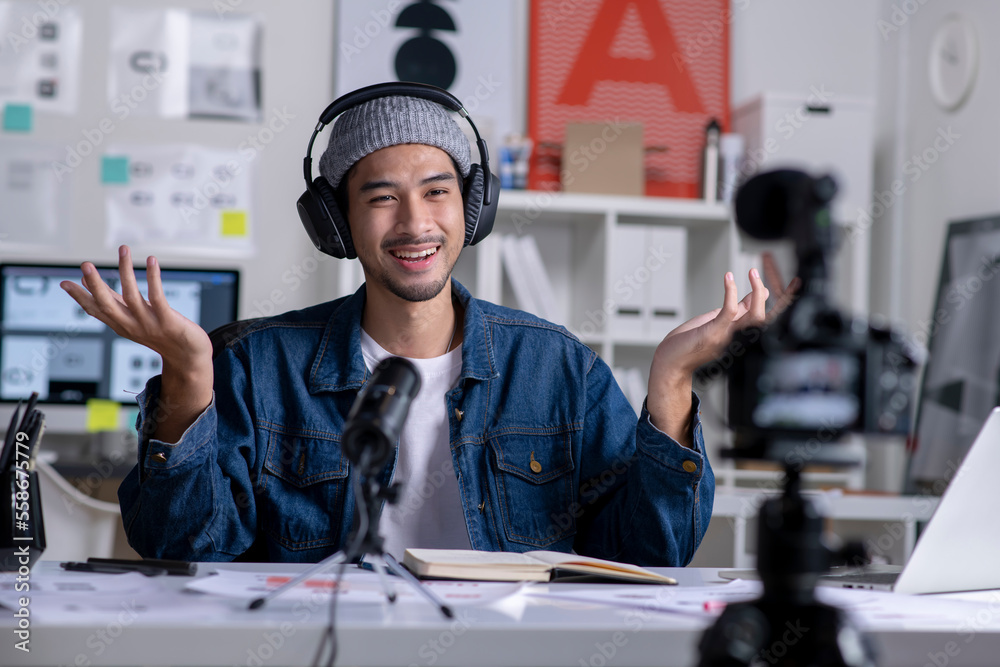 Young Asian male graphic designer blogger influencer talking looking at camera shooting education tu