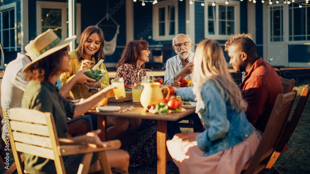 Parents, Children and Friends Gathered at a Barbecue Dinner Table Outside a Beautiful Home. Multicul