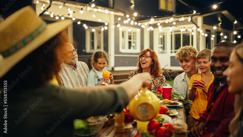 Family and Multicultural Friends Celebrating Outside at Home in the Evening. Group of Children, Adul