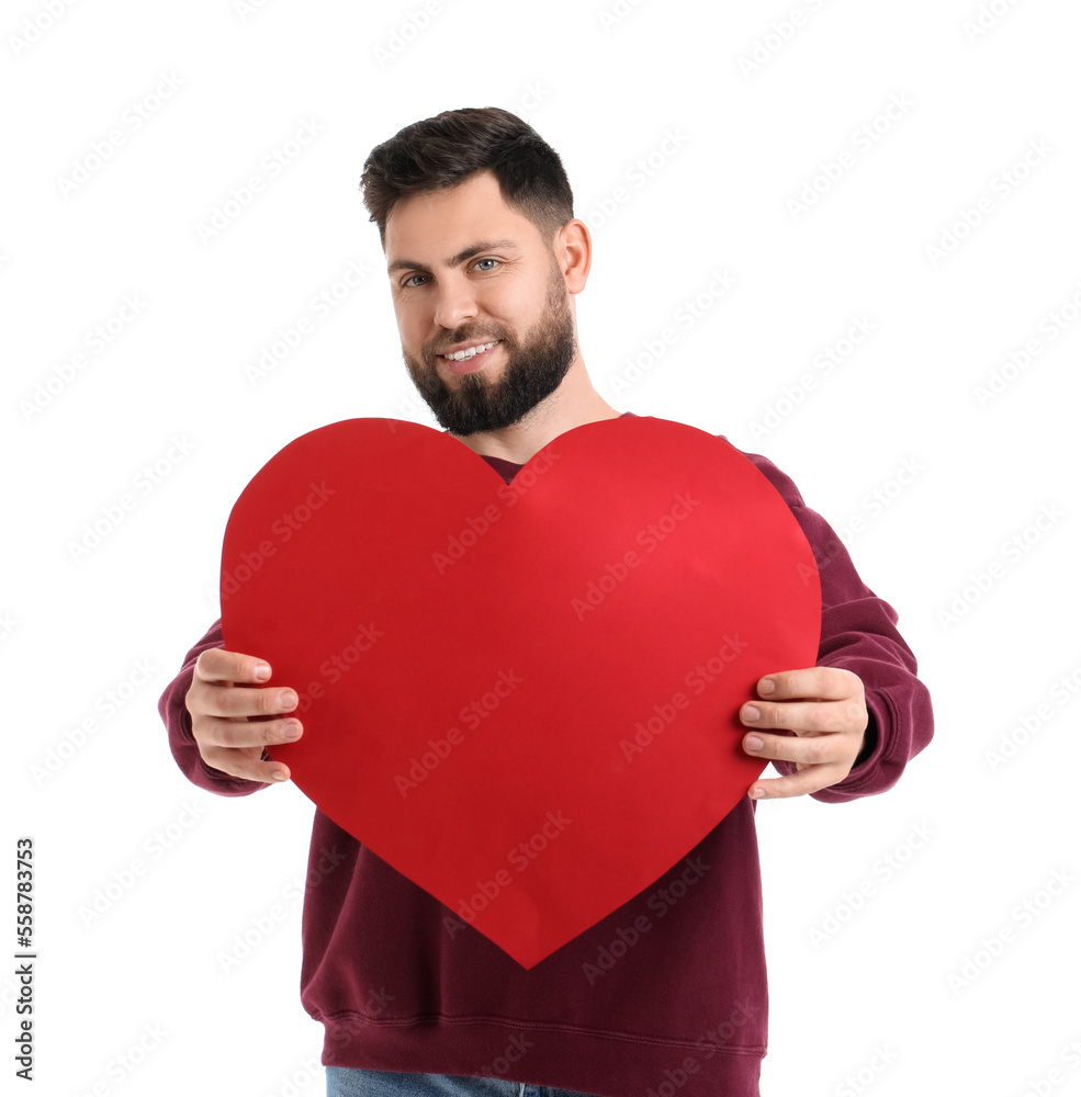 Young bearded man with big paper heart for Valentines Day on white background