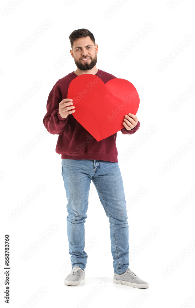 Young bearded man with big paper heart for Valentines Day on white background