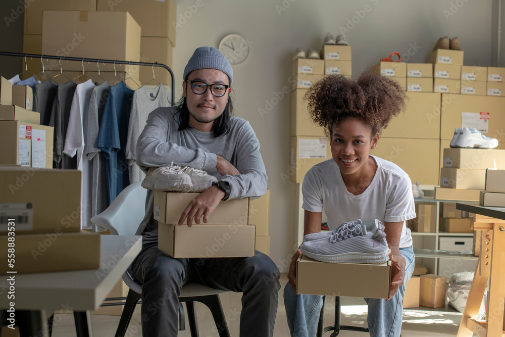 Confident mixed race young couple of Asian man and African-American woman retail seller, entrepreneu