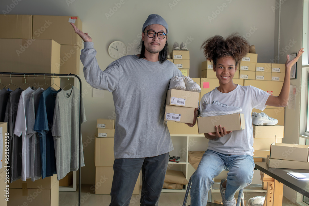 Confident mixed race young couple of Asian man and African-American woman retail seller, entrepreneu