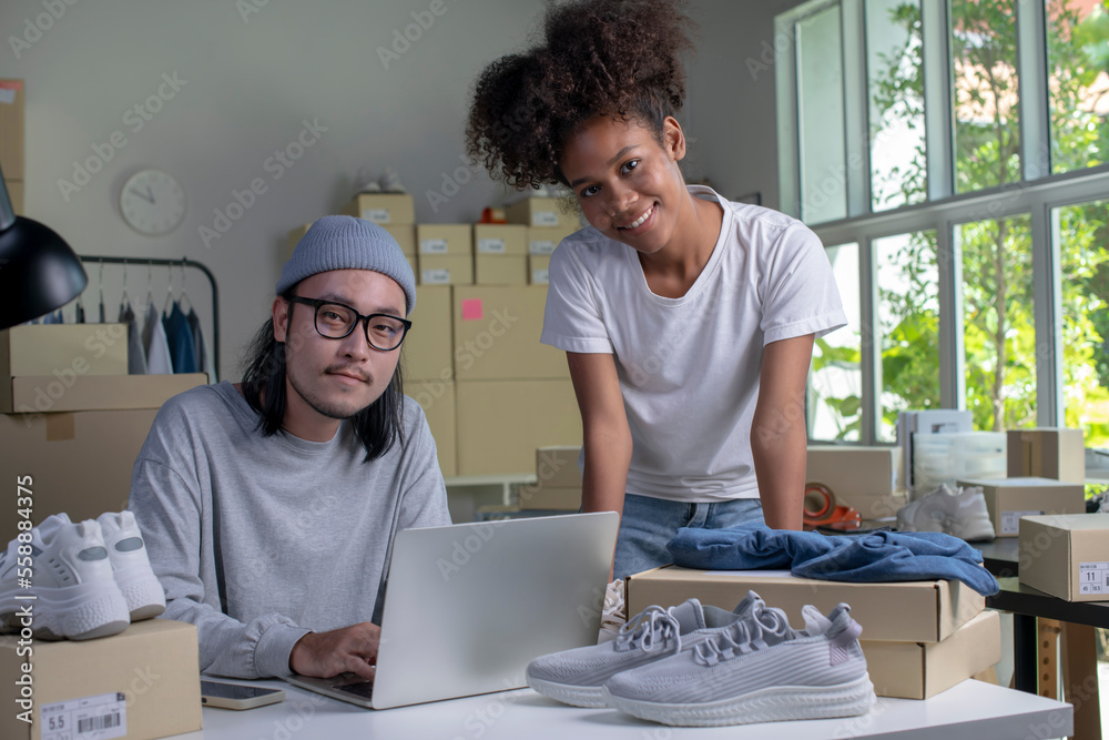 Confident mixed race young couple of Asian man and African-American woman retail seller, entrepreneu