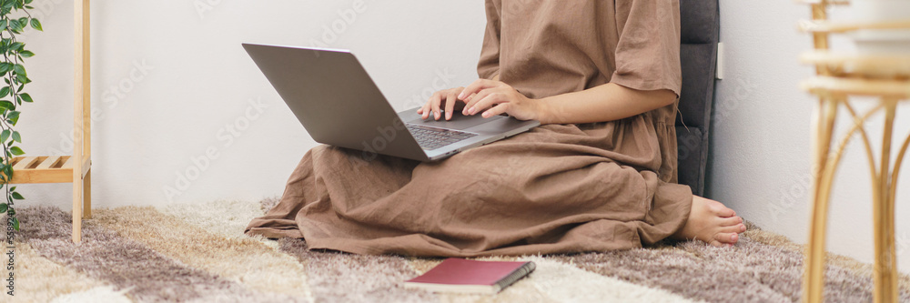 Relaxation lifestyle concept, Young Asian woman use laptop for entertainment in living room at home