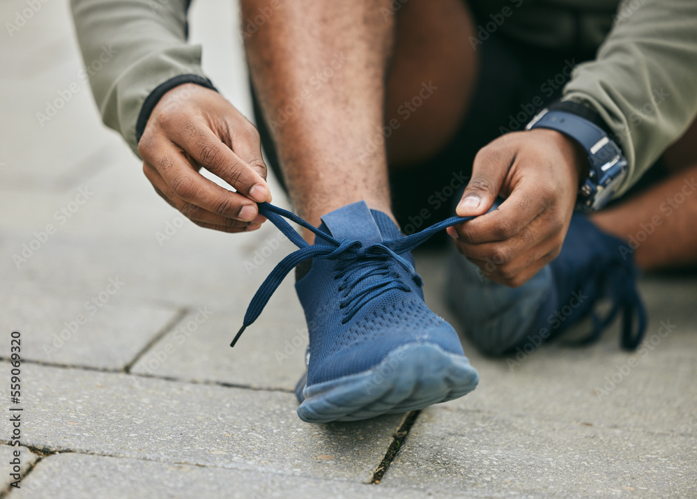 Fitness, hands and black man tie shoes in city and getting ready for running, workout or exercise. W