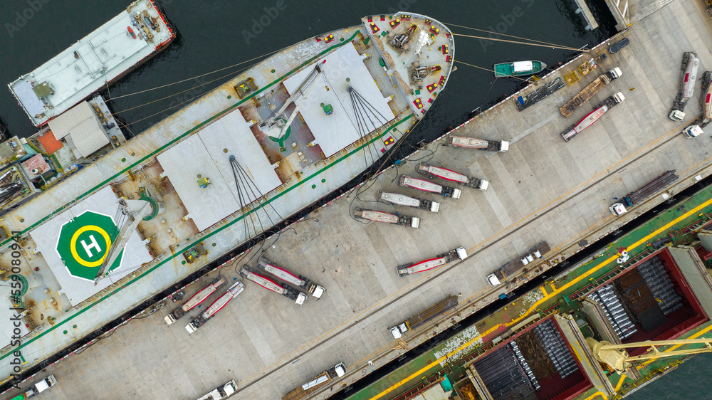 Powder tanker trailer Truck going to load cemant powder to large ship at teminal dock export. powder