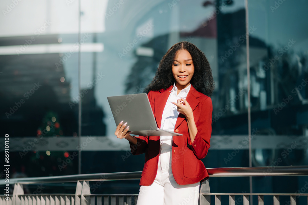 Portrait of Asian business woman holding laptop.Office worker at business center..