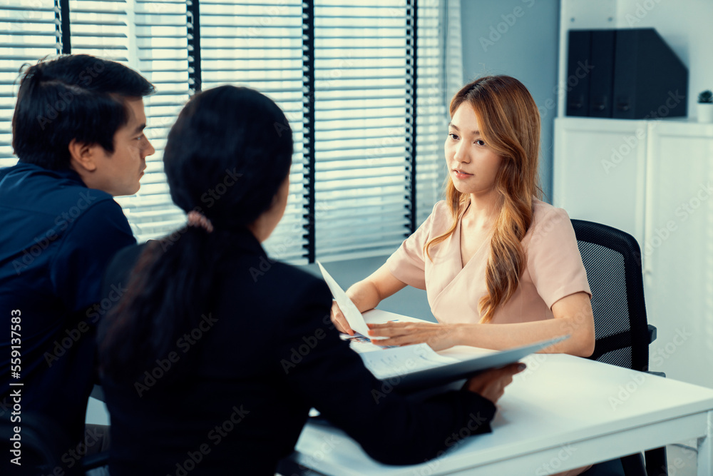 A young female asian candidate tries to impress her interviewer by being competent. International co